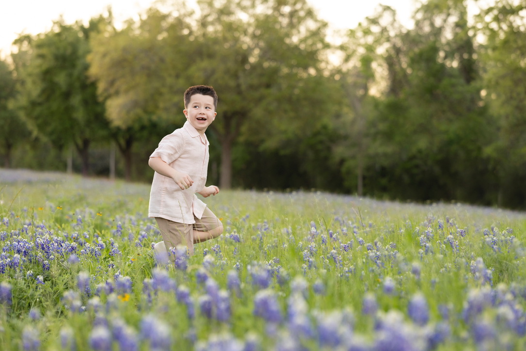 Cy running through bluebonnets